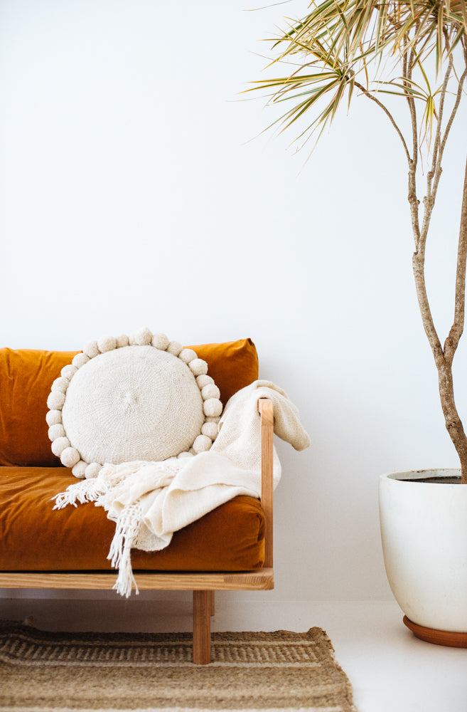 Pampa round white pom pom cushion