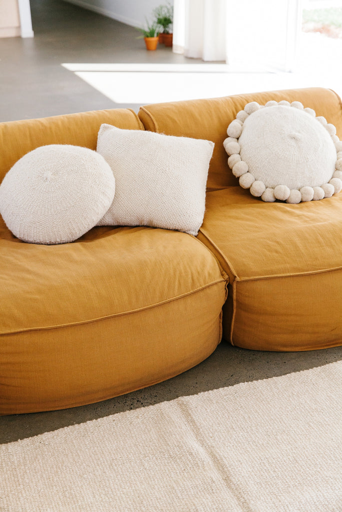 Pampa round white pom pom cushion